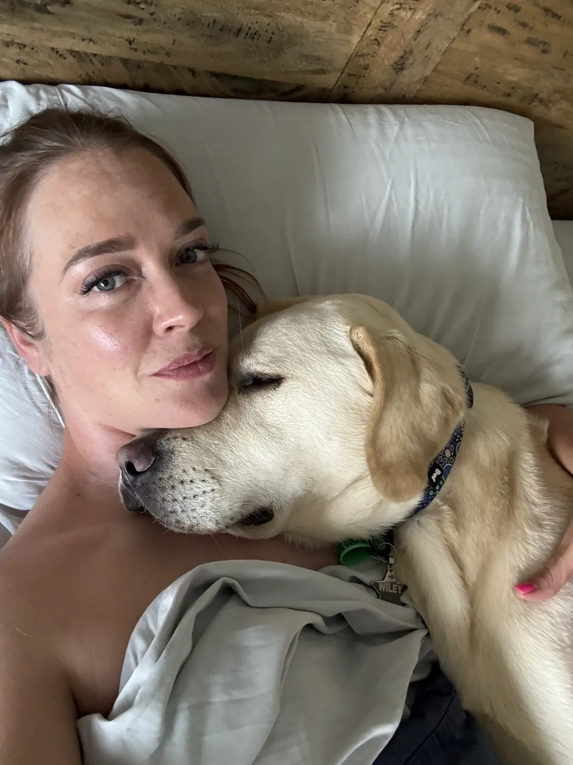 Zoe cuddling a Labrador